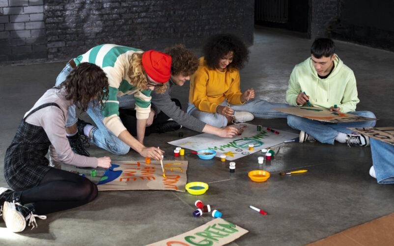 people-making-banners-full-shot