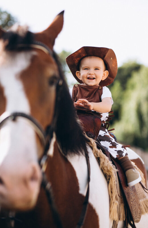 Little cowboy sitting on a horse